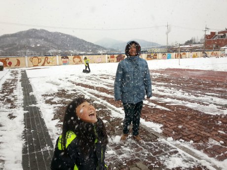 Happy students playing in the snow. 
